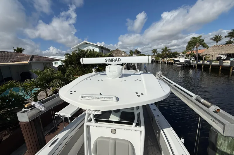  Yacht Photos Pics 2023 Cape Horn 32 XS boat docked by a canal under a clear blue sky.