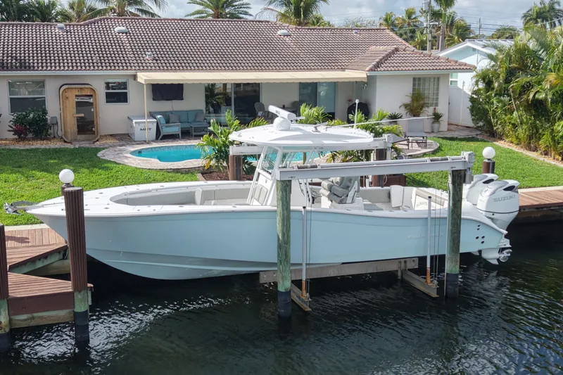  Yacht Photos Pics 2023 Cape Horn 32 XS boat docked by a waterfront home with a pool.