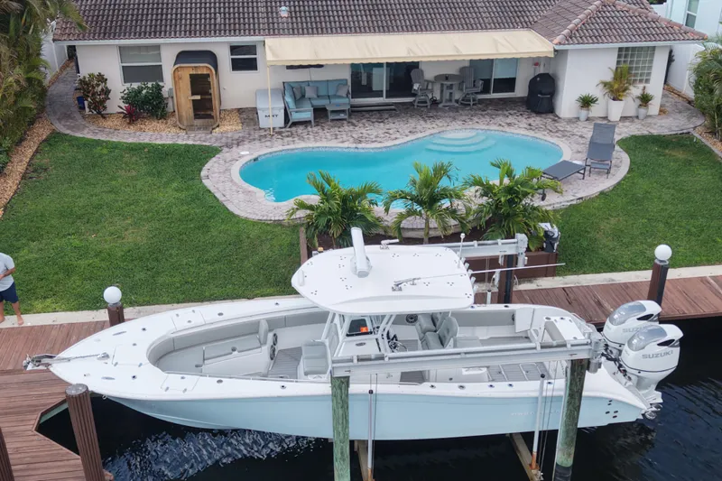  Yacht Photos Pics 2023 Cape Horn 32 XS boat docked by a poolside home.