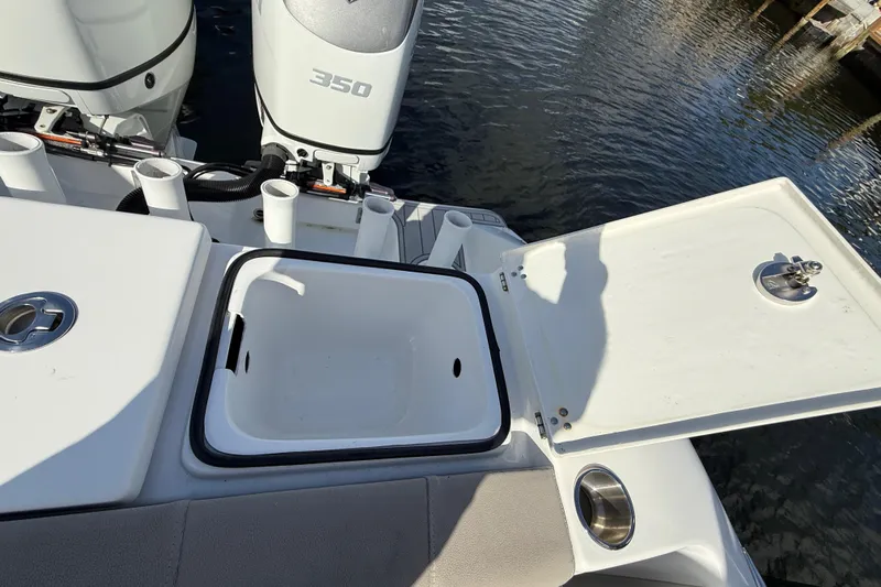  Yacht Photos Pics 2023 Cape Horn 32 XS boat with open storage compartment and twin outboard engines.