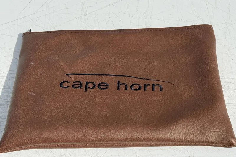  Yacht Photos Pics Brown leather pouch with "Cape Horn" logo, related to 2023 Cape Horn 32 XS model.
