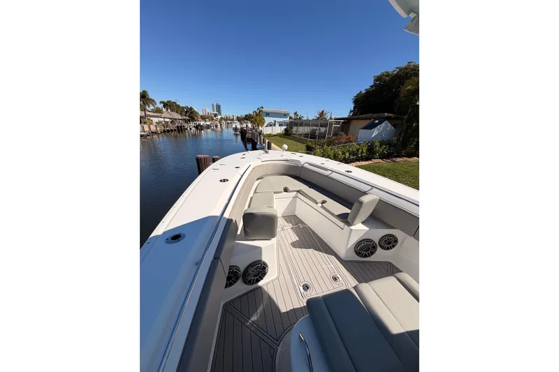  Yacht Photos Pics 2023 Cape Horn 32 XS boat interior with seating and speakers, docked by a canal.