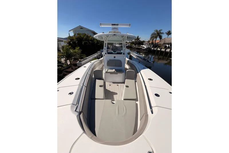  Yacht Photos Pics 2023 Cape Horn 32 XS boat with spacious deck and seating, docked near palm trees.