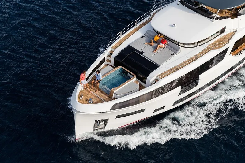  Yacht Photos Pics Luxurious 2027 Sirena 88 yacht cruising with people relaxing on deck in open sea.