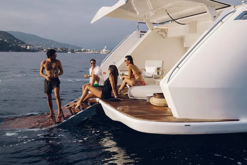  Yacht Photos Pics People enjoying leisure time on a 2027 Sirena 88 yacht deck.