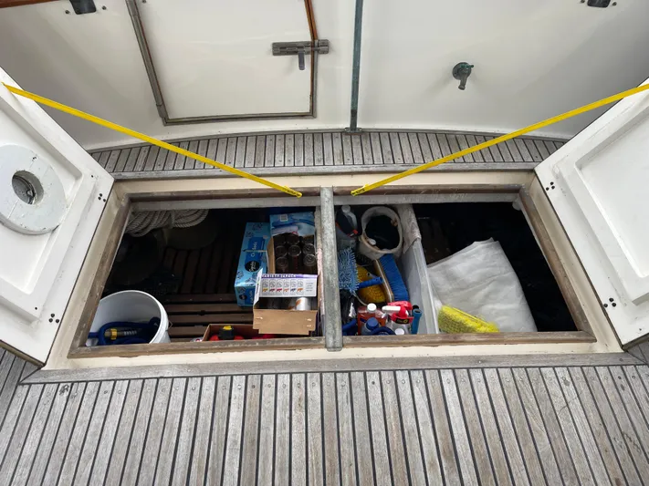  Yacht Photos Pics Storage compartment on 1980 Grand Banks 42 Europa boat deck, filled with supplies and equipment.
