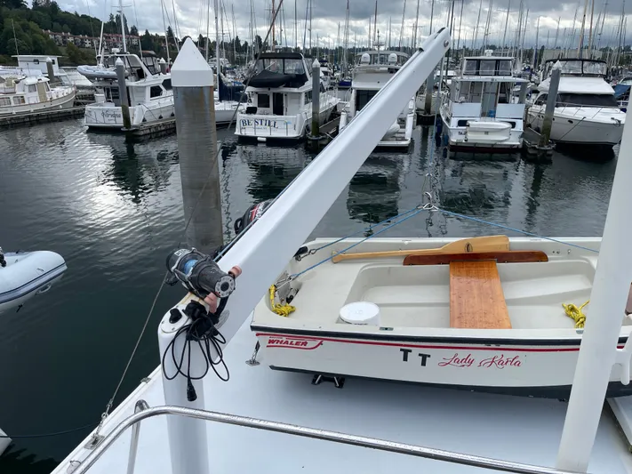  Yacht Photos Pics 1980 Grand Banks 42 Europa yacht in marina with small boat on deck.