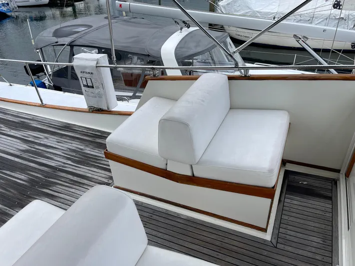  Yacht Photos Pics 1980 Grand Banks 42 Europa yacht with white cushioned seating on deck.