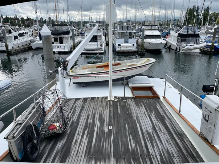  Yacht Photos Pics 1980 Grand Banks 42 Europa yacht docked at marina with dinghy and crab pot.