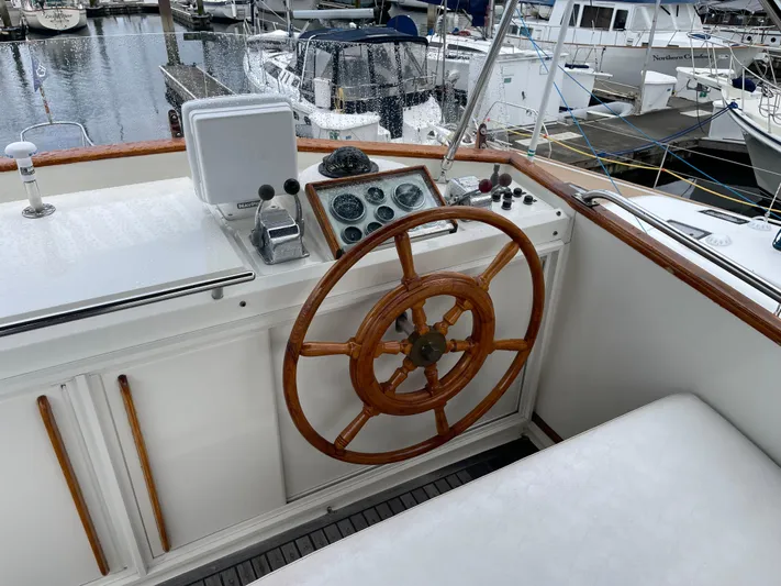  Yacht Photos Pics 1980 Grand Banks 42 Europa helm with wooden wheel and navigation instruments.