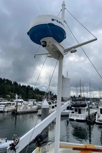  Yacht Photos Pics 1980 Grand Banks 42 Europa at marina with radar equipment, cloudy sky.