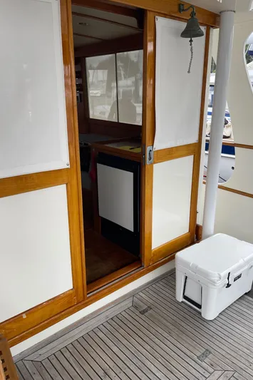  Yacht Photos Pics 1980 Grand Banks 42 Europa yacht with wooden sliding door and deck cooler.