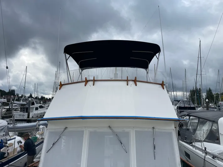  Yacht Photos Pics 1980 Grand Banks 42 Europa yacht docked under cloudy skies.