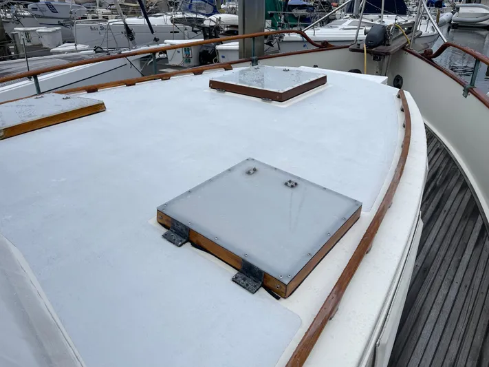  Yacht Photos Pics Deck of 1980 Grand Banks 42 Europa yacht with wooden accents in a marina.