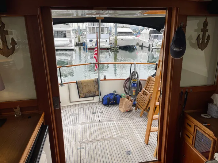  Yacht Photos Pics Interior view of 1980 Grand Banks 42 Europa yacht with marina backdrop.