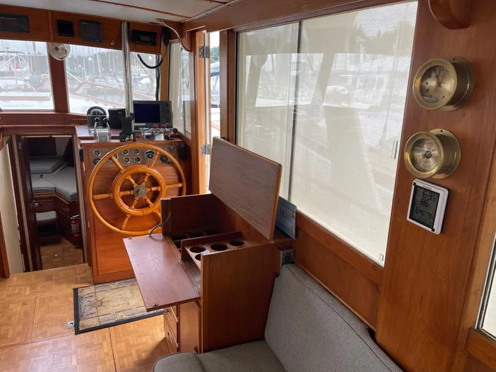  Yacht Photos Pics Interior of 1980 Grand Banks 42 Europa yacht with wooden helm and seating area.