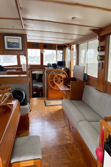  Yacht Photos Pics Interior of 1980 Grand Banks 42 Europa yacht with wooden furnishings and steering wheel.