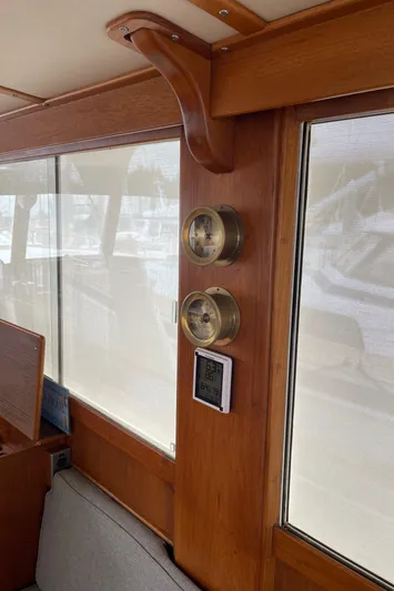 Yacht Photos Pics Interior of 1980 Grand Banks 42 Europa yacht with wooden paneling and nautical instruments.