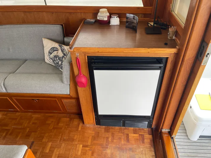  Yacht Photos Pics Interior of 1980 Grand Banks 42 Europa with fridge and seating area.
