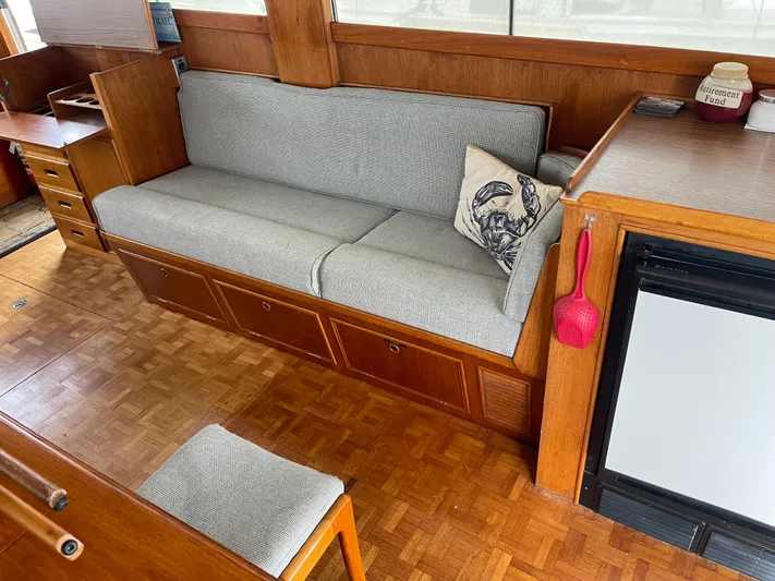  Yacht Photos Pics Interior of 1980 Grand Banks 42 Europa with wooden flooring and gray seating.