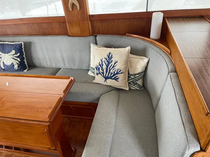  Yacht Photos Pics Cozy seating area on 1980 Grand Banks 42 Europa with nautical-themed cushions.