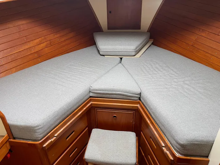  Yacht Photos Pics Cozy cabin interior of 1980 Grand Banks 42 Europa with wooden paneling and gray cushions.