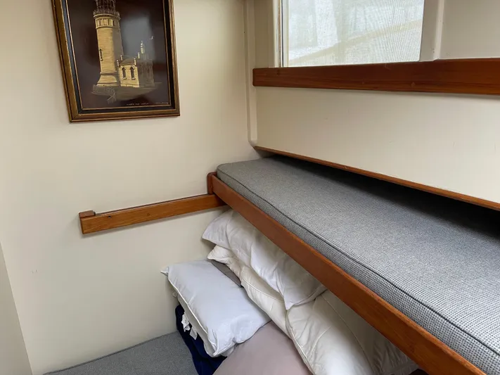  Yacht Photos Pics Cozy cabin interior of 1980 Grand Banks 42 Europa with bunk beds and lighthouse painting.