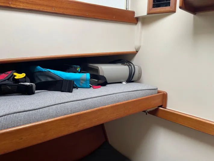  Yacht Photos Pics Interior of 1980 Grand Banks 42 Europa with storage bench and nautical gear.