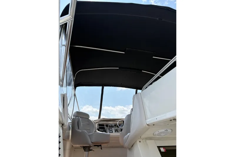  Yacht Photos Pics 2003 Regal Commodore 3880 boat interior with helm and seating under canopy.