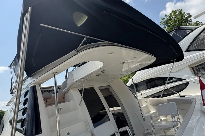  Yacht Photos Pics 2003 Regal Commodore 3880 yacht with canopy, docked under clear sky.