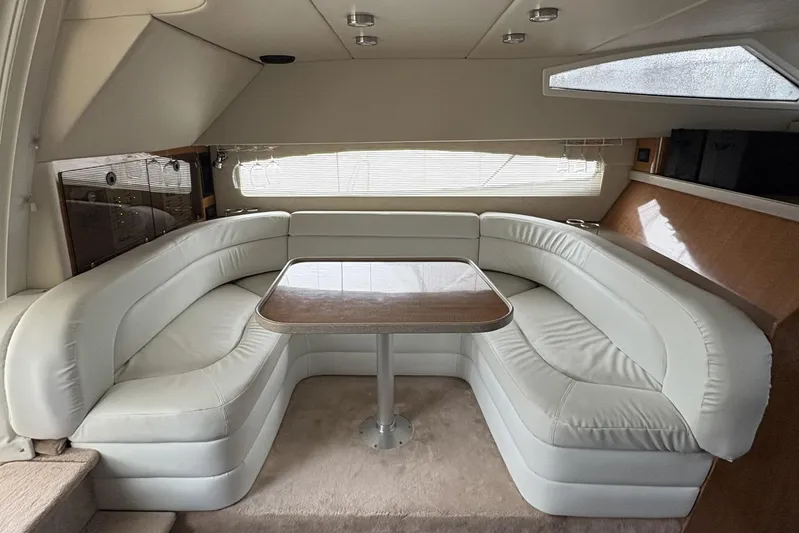  Yacht Photos Pics Luxurious interior of 2003 Regal Commodore 3880 yacht with plush seating and wooden table.