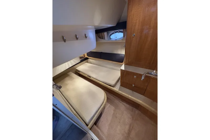  Yacht Photos Pics 2003 Regal Commodore 3880 cabin interior with twin beds and wooden cabinetry.