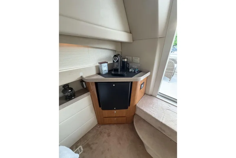  Yacht Photos Pics 2003 Regal Commodore 3880 yacht interior with kitchenette and coffee maker.