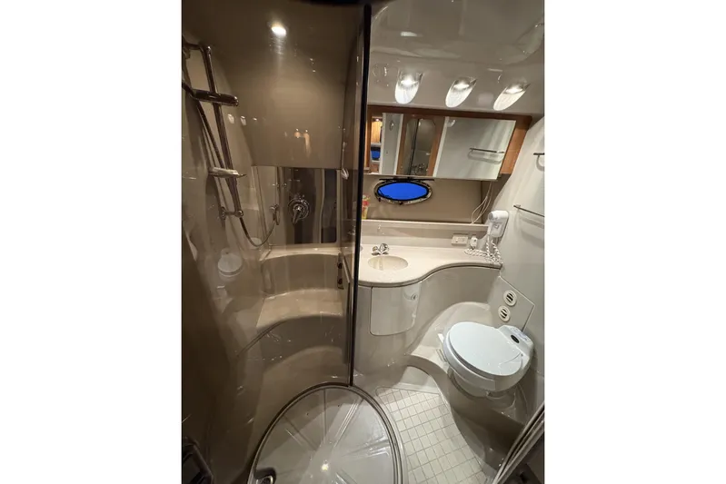  Yacht Photos Pics Luxurious bathroom in 2003 Regal Commodore 3880 yacht with shower, sink, and toilet.