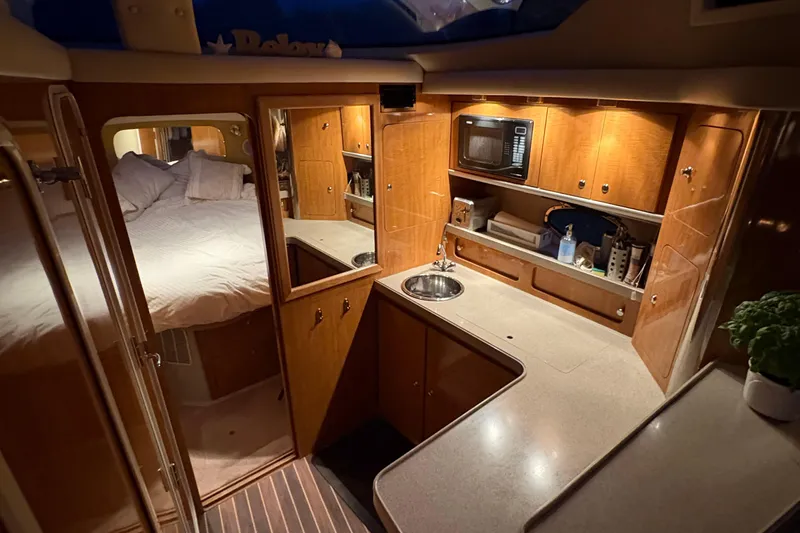  Yacht Photos Pics Interior of 2003 Regal Commodore 3880 yacht with cozy bedroom and modern kitchenette.