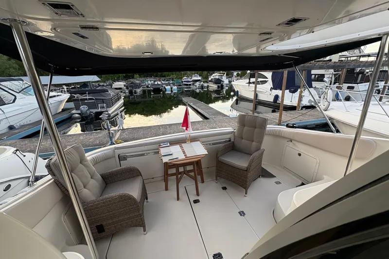  Yacht Photos Pics 2003 Regal Commodore 3880 yacht interior with seating and table at marina.