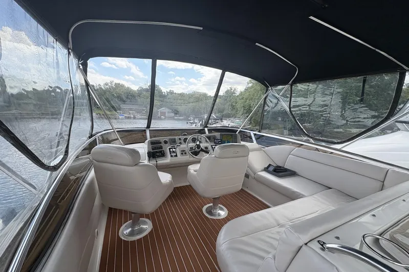  Yacht Photos Pics 2003 Regal Commodore 3880 yacht interior with white seating and wood flooring.