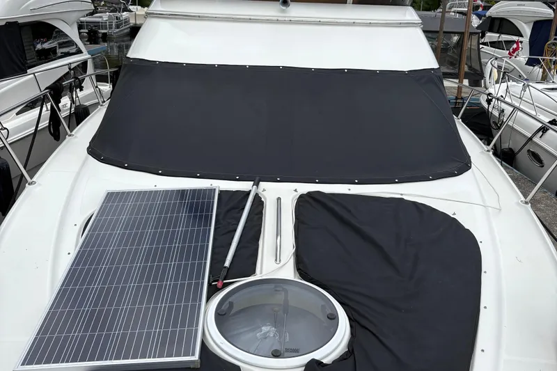  Yacht Photos Pics 2003 Regal Commodore 3880 yacht with solar panel and covered windshield.