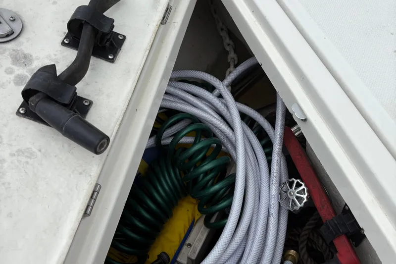  Yacht Photos Pics Storage compartment on a 2003 Regal Commodore 3880 boat with coiled hoses and equipment.