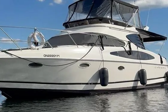  Yacht Photos Pics 2003 Regal Commodore 3880 yacht on calm water under a clear sky.