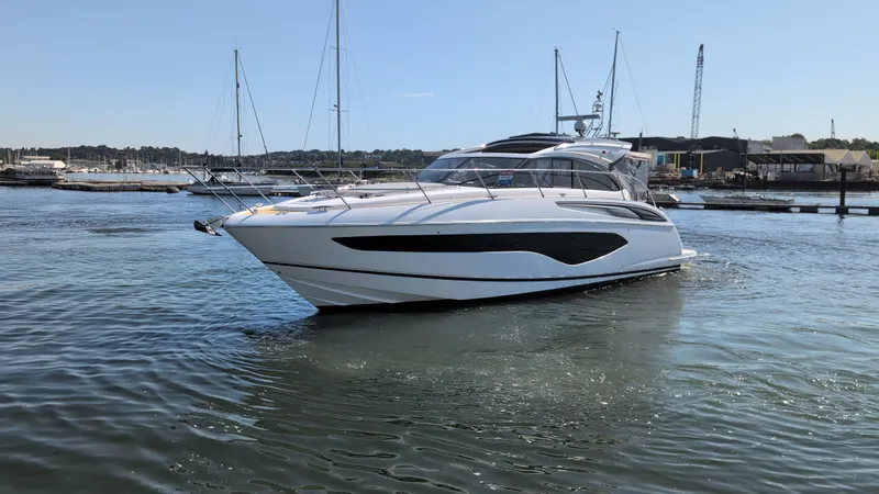  Yacht Photos Pics 2021 Princess V50 yacht docked in a marina, showcasing sleek design and luxury features.