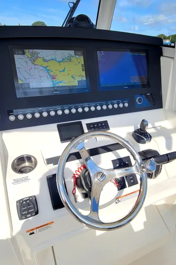 Carly Rose Yacht Photos Pics 2023 Regulator 34 boat helm with dual navigation screens and steering wheel.