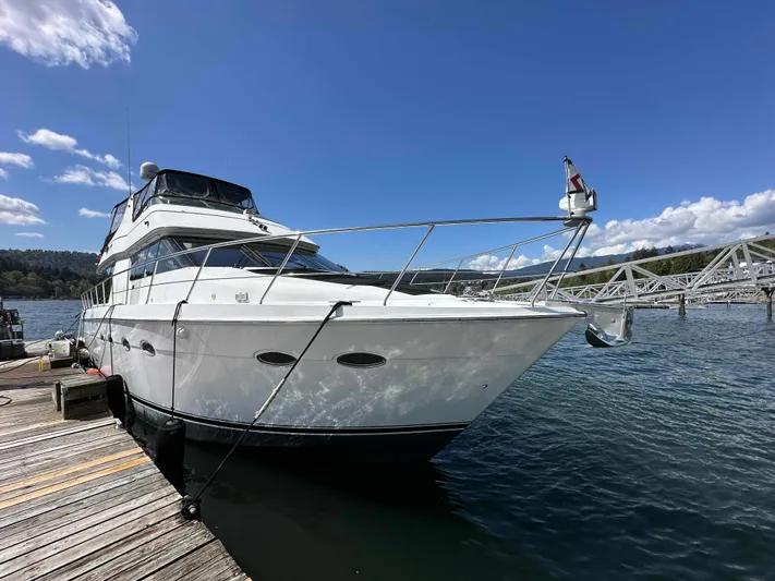  Yacht Photos Pics 2001 Carver 570 Voyager Pilothouse yacht docked on a sunny day.