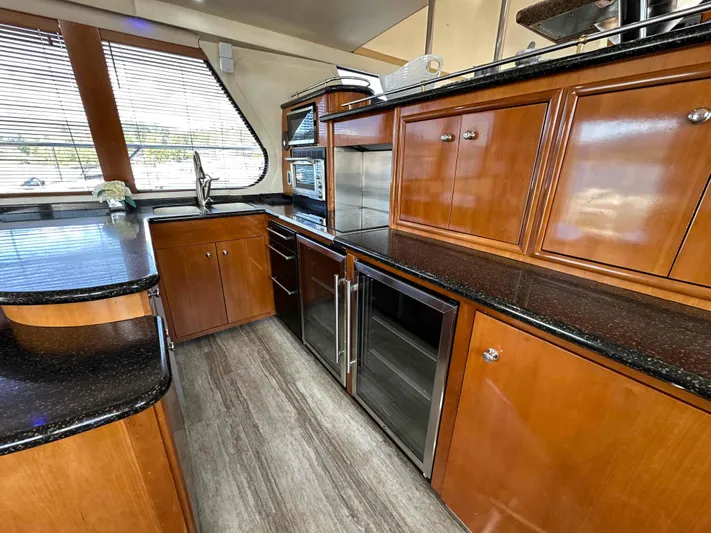  Yacht Photos Pics Luxurious kitchen interior of 2001 Carver 570 Voyager Pilothouse with wood cabinetry and modern appliances.