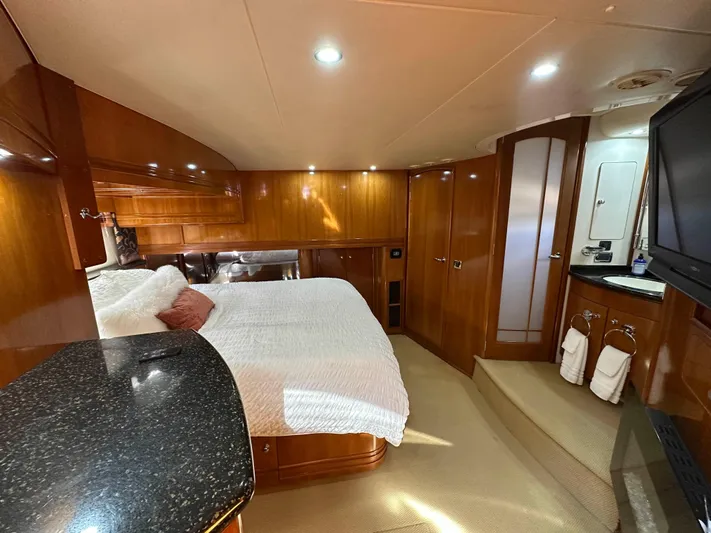  Yacht Photos Pics Luxurious 2001 Carver 570 Voyager Pilothouse bedroom with elegant wood finishes and modern amenities.
