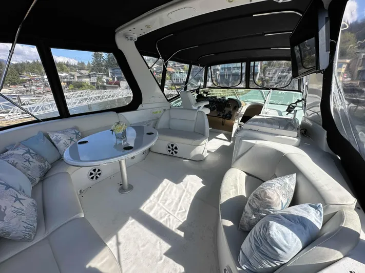  Yacht Photos Pics Luxurious interior of 2001 Carver 570 Voyager Pilothouse with plush seating and elegant decor.