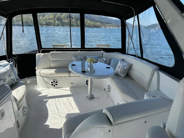  Yacht Photos Pics Luxurious 2001 Carver 570 Voyager Pilothouse yacht interior with elegant seating and scenic water views.