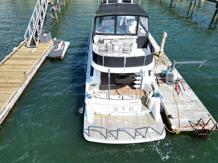  Yacht Photos Pics 2001 Carver 570 Voyager Pilothouse docked at marina, aerial view.