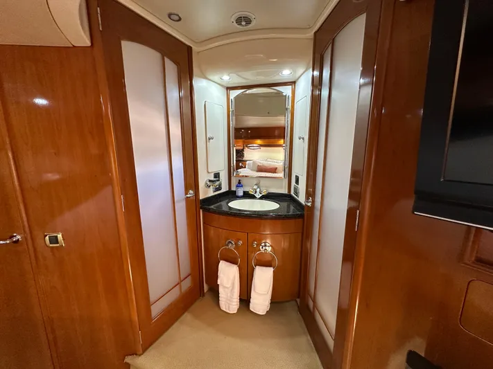  Yacht Photos Pics Luxurious bathroom in 2001 Carver 570 Voyager Pilothouse yacht with wood accents and modern fixtures.