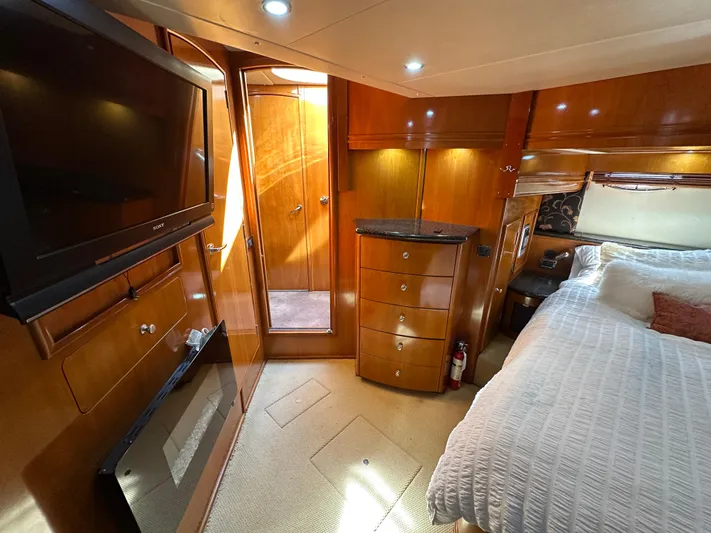  Yacht Photos Pics Luxurious interior of 2001 Carver 570 Voyager Pilothouse with wood finishes and cozy bedroom.